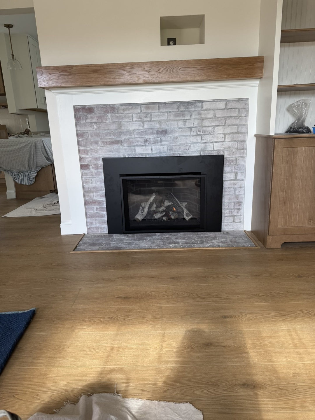 Built-in gas fireplace installation by Hearth Doctor with whitewashed brick surround