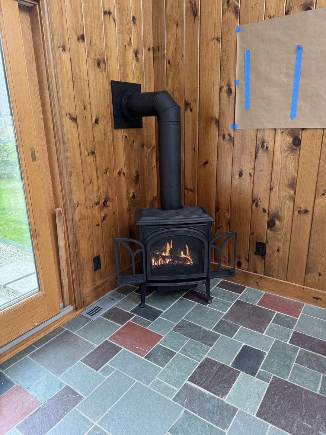 Gas stove installation by Hearth Doctor in a Maine home with wood-paneled walls