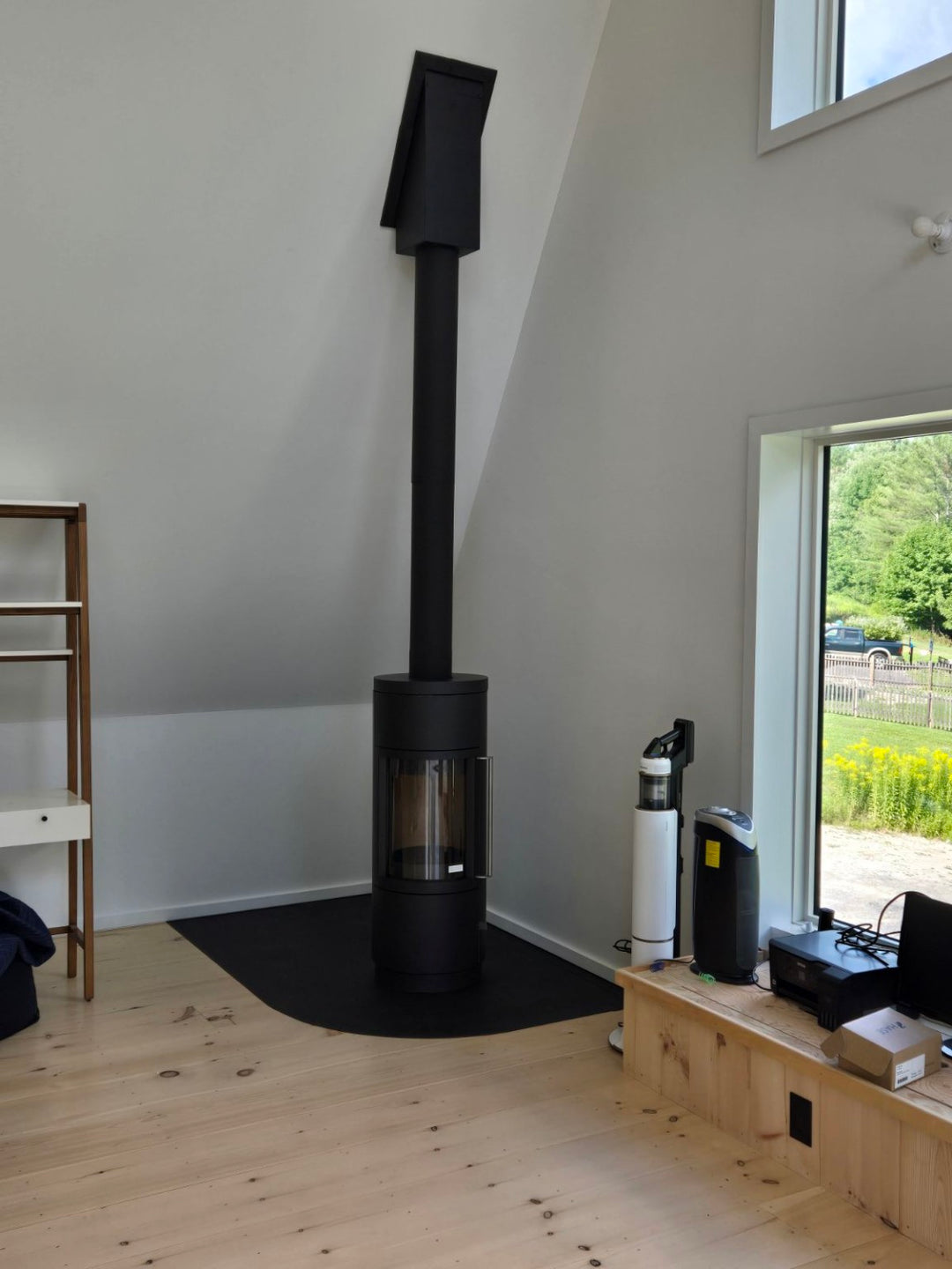 Modern freestanding stove installed by Hearth Doctor in a bright Maine home