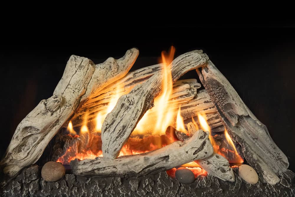 Valor Madrona gas stove with driftwood logs